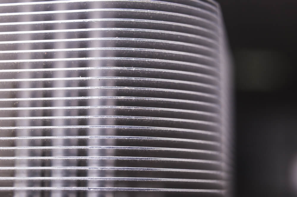 Close-up of a textured surface with parallel lines, highlighting how keeping your furnace filter clean helps you save energy