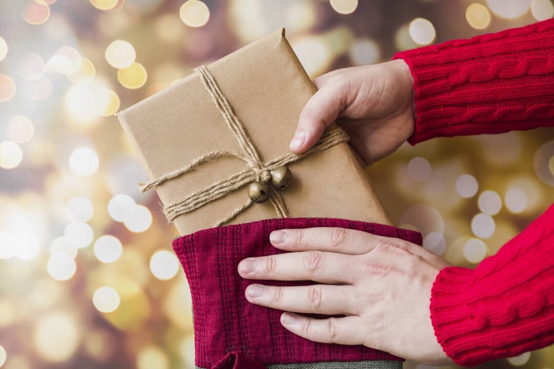 Person taking a gift from a Christmas sock, as a blog header image of a post about the GOWOOD annual Christmas Giveaway 2024