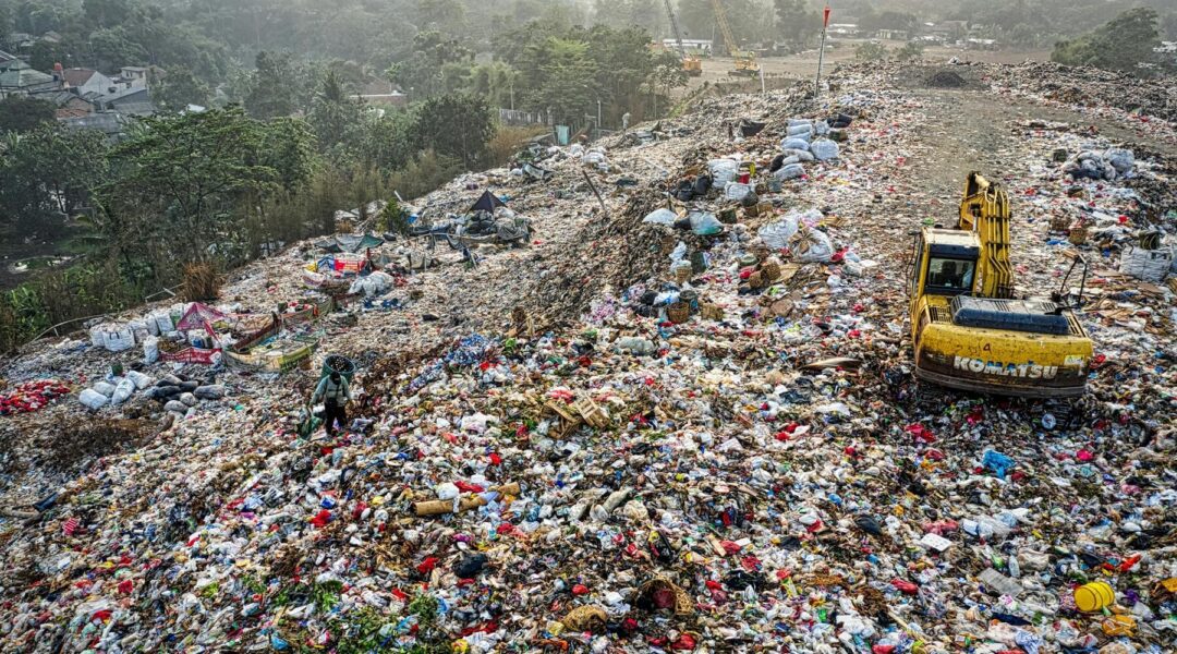 A room filled with discarded electronic waste and other debris, highlighting the urgent need to reduce plastic pollution