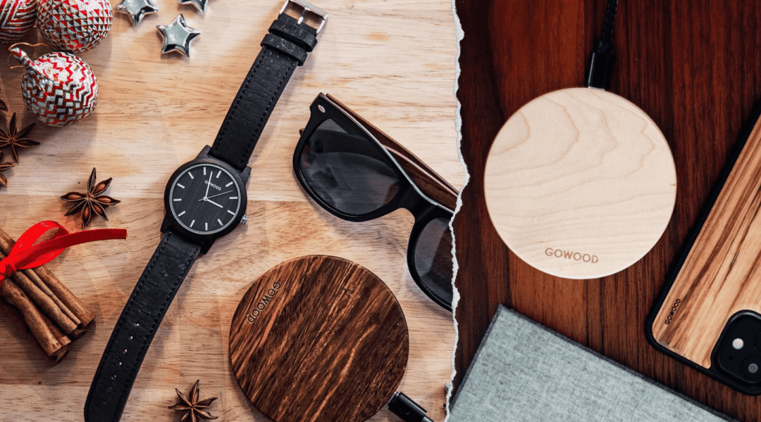 A festive arrangement of wooden accessories, including a GOWOOD wooden wireless charger and a watch, sunglasses, perfect for Christmas gifting